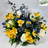 A clear crystal glass cross anchors this devotional sympathy arrangement, framed by