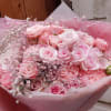 Bouquet of pink roses wrapped in pink paper