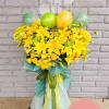 Yellow floral arrangement with balloons and a clear balloon topper