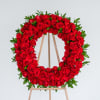 Red rose wreath on a wooden easel