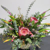 Large mixed bouquet with pink protea and yellow lilies in a vase