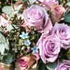 Bouquet of lavender and blush roses with small blue flowers