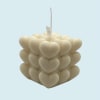 Stacked cream heart-shaped candles with a hanging tag
