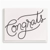 White card with the word "Congrats" in black script
