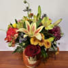 A ceramic container with an abundant fall bouquet.
