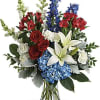 This bouquet features blue hydrangea, red roses, white asiatic lilies, red alstroemeria