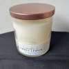 White soy wax candle in a glass jar with a copper lid labeled lavender and sweet lemon