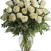 White roses arranged in a clear glass vase