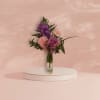 Pink and purple bouquet in a clear glass vase