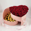 Heart-shaped box with red roses and gold-wrapped chocolates