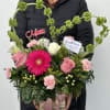 Pink and white mixed bouquet in a gift box with a heart-shaped green accent