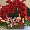 Heart-shaped red rose arrangement with pink lilies in a wooden box