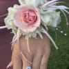 Pink and white floral wrist corsage with ribbon streamers