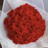 Bouquet of red roses wrapped in white paper