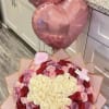 Heart-shaped rose bouquet with pink balloons