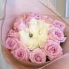 Bouquet of pink and white roses wrapped in pink paper