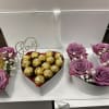 Heart-shaped gift boxes with purple roses and chocolates