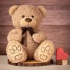 A soft and cuddly mocha teddy bear with curly plush fur, embroidered