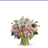 Pink and white rose bouquet in a clear glass vase