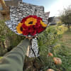 Bouquet of red roses and yellow sunflowers wrapped in patterned paper