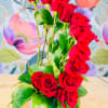 A dramatic column of vivid red roses draws the eye upward in