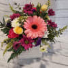 Mixed bouquet in a white wooden box with pink, yellow, and white flowers