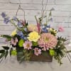 Mixed pastel flower arrangement in a wooden box