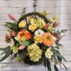 Mixed bouquet with orange and yellow blooms and pink tulips