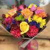 Bright mixed bouquet of roses, carnations, and daisies with butterfly picks