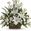White lilies and carnations arranged in a wicker basket