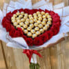 Heart-shaped bouquet of red roses with gold-wrapped chocolates