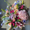 Large bouquet of pink lilies, roses, hydrangea, and blue accent flowers