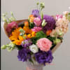 Hand-tied bouquet of pink, purple, orange, and white flowers