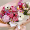 Pink and white mixed bouquet with gerbera daisies and roses wrapped in pastel paper