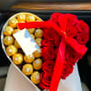 Heart-shaped box with red roses and gold-wrapped chocolates tied with a red ribbon