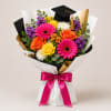 Bursting with vibrant pink gerbera daisies, sunny yellow roses, and cheerful orange
