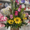 Mixed bouquet with yellow sunflowers, pink roses, and a heart balloon in a wooden box