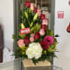 Tall bouquet of pink and red roses with white hydrangea in a wooden box