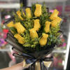 Bouquet of yellow roses wrapped in black paper with a ribbon