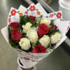 Bouquet of red and white roses wrapped in floral paper