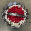 Round bouquet of red roses with white baby's breath and a ribbon