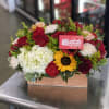 Mixed bouquet in a wooden box with red roses, white hydrangea, and a sunflower