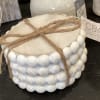 White beaded decorative container tied with twine