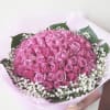 Large bouquet of pink roses with white baby's breath in pastel wrapping