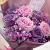 Pink and purple rose bouquet with baby's breath and a Valentine's Day card