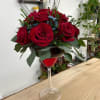 Red roses arranged in a wine glass vase