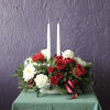 Red and white rose centerpiece with two white taper candles