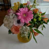 Mixed bouquet with pink gerbera, roses, hydrangea, and alstroemeria in a yellow vase