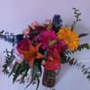 Colorful mixed bouquet in a vase with gerbera daisies, roses, lilies, and anthurium
