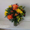 Bouquet of orange roses, yellow chrysanthemums, and mixed blooms in a glass vase